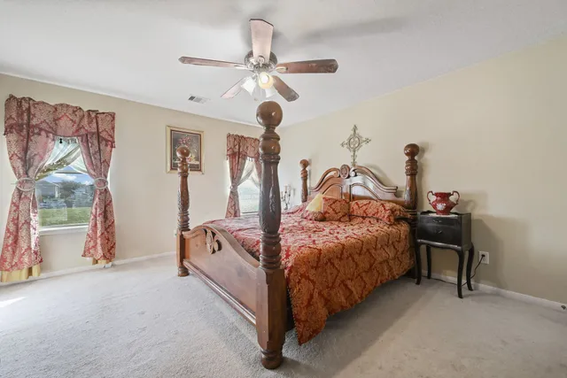 a bed room with a bed and a chandelier