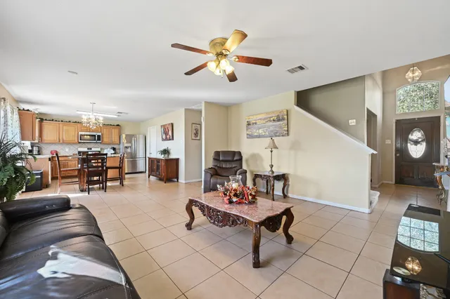 a living room with furniture and kitchen view