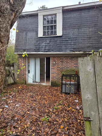 a brick building with a bench in front of it