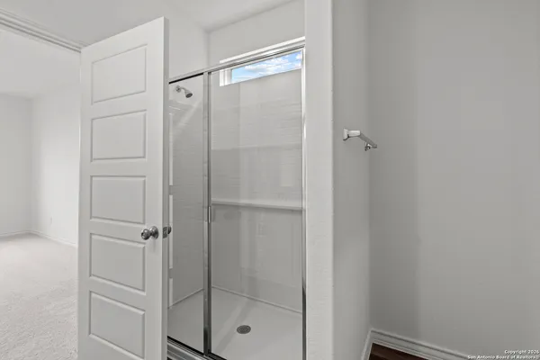 a bathroom with a glass shower door