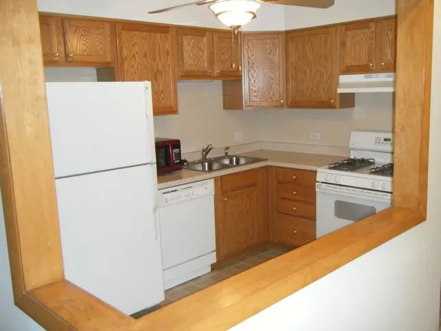 a kitchen with a sink a stove a refrigerator and cabinets