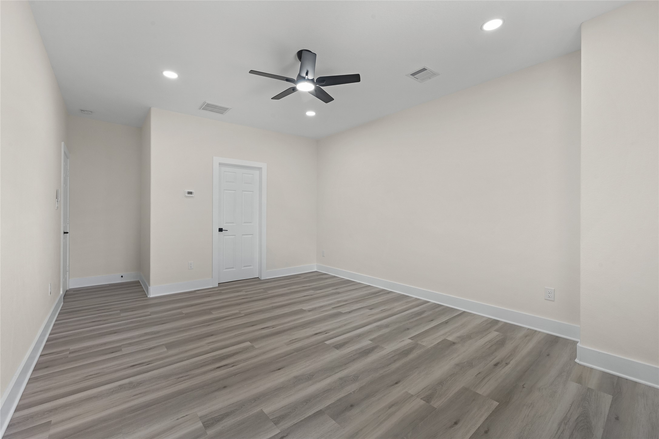 9807 Bamboo Road, Unit A Houston, TX 77041 - Photo 12 of 25 Step into this beautiful new construction home offering contemporary style, an open-concept layout, and thoughtfully selected finishes throughout. The spacious living, dining, and kitchen areas flow together seamlessly, creating an inviting space. The kitchen features crisp white cabinetry, quartz-style countertops, and a large center island, while wood-look tile flooring adds warmth and durability throughout the first floor. Upstairs, spacious bedrooms are filled with natural light and include ceiling fans