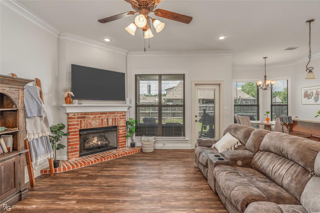 711 Reeds Reef Bossier City, LA 71112 - Photo 7 of 36 a living room with furniture a fireplace and a flat screen tv