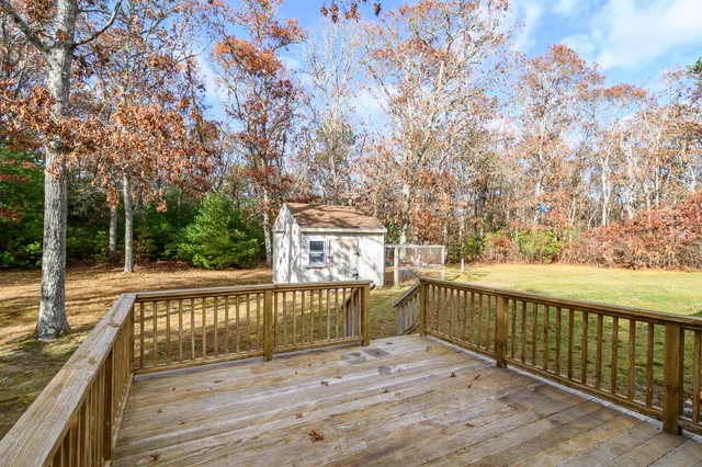a view of deck and yard with wooden fence
