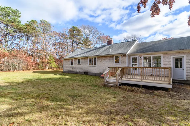 a view of a house with a yard and deck