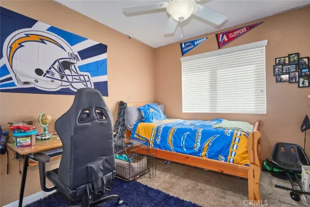 a bedroom with a bed and a bookshelf