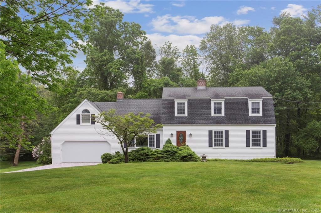 9 Powder Horn Drive Ridgefield, CT 06877 - Photo 1 of 1 a front view of a house with a yard and trees