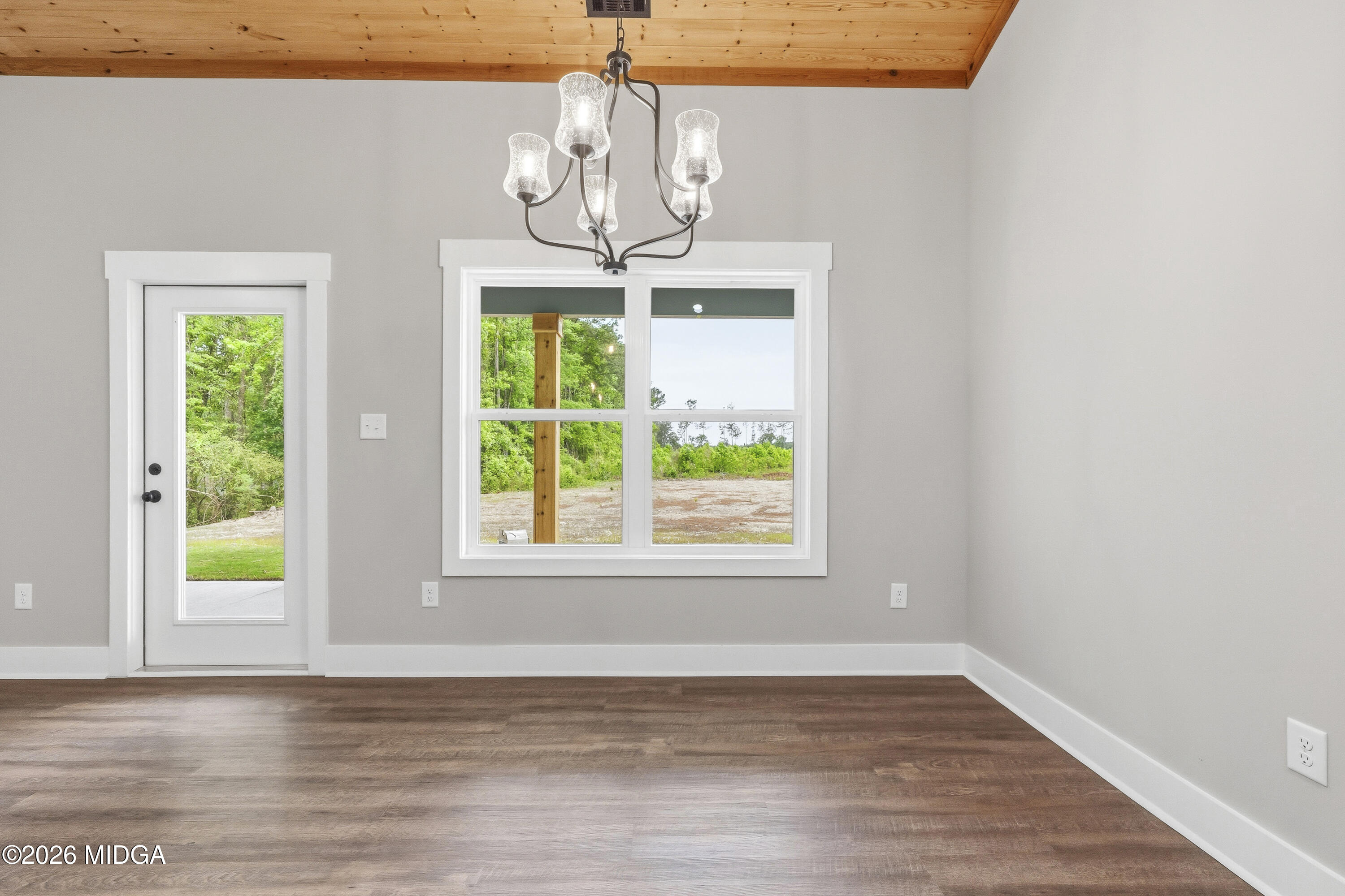 146 Overland Way Gray, GA 31032 - Photo 16 of 38 a view of a room with wooden floors chandelier and windows