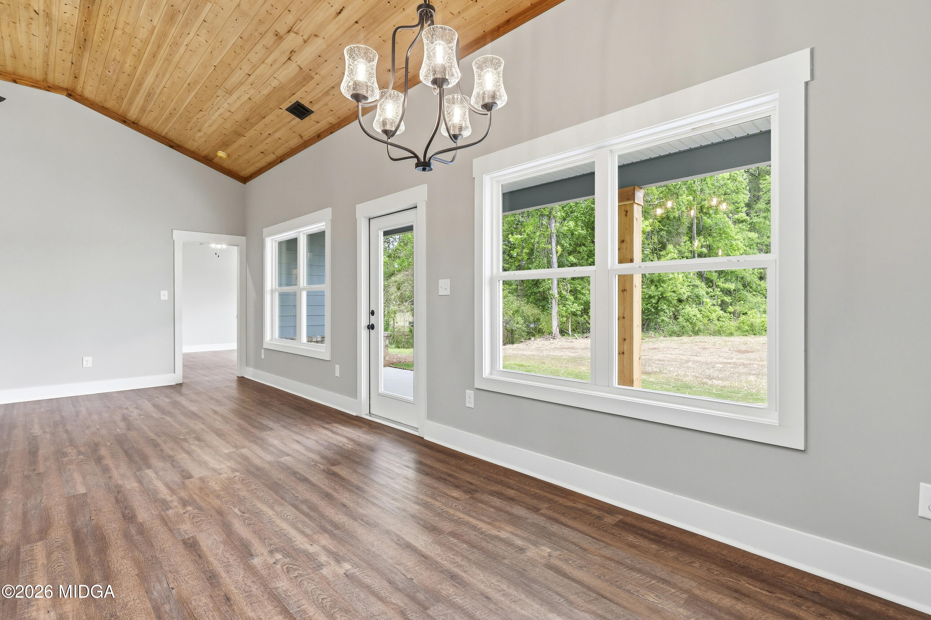 146 Overland Way Gray, GA 31032 - Photo 17 of 38 a view of an empty room with wooden floor and a window