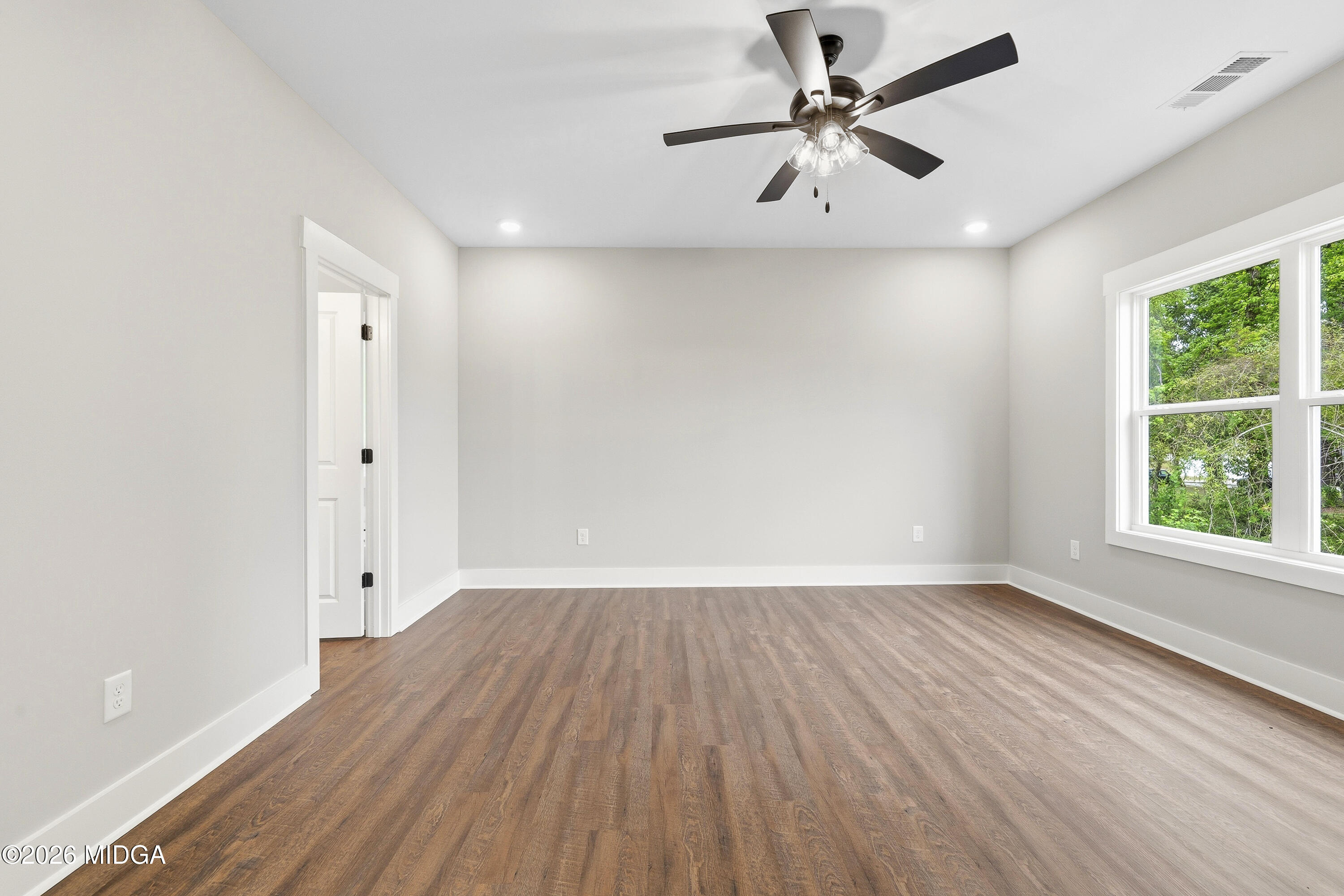 146 Overland Way Gray, GA 31032 - Photo 21 of 38 wooden floor in an empty room with a window
