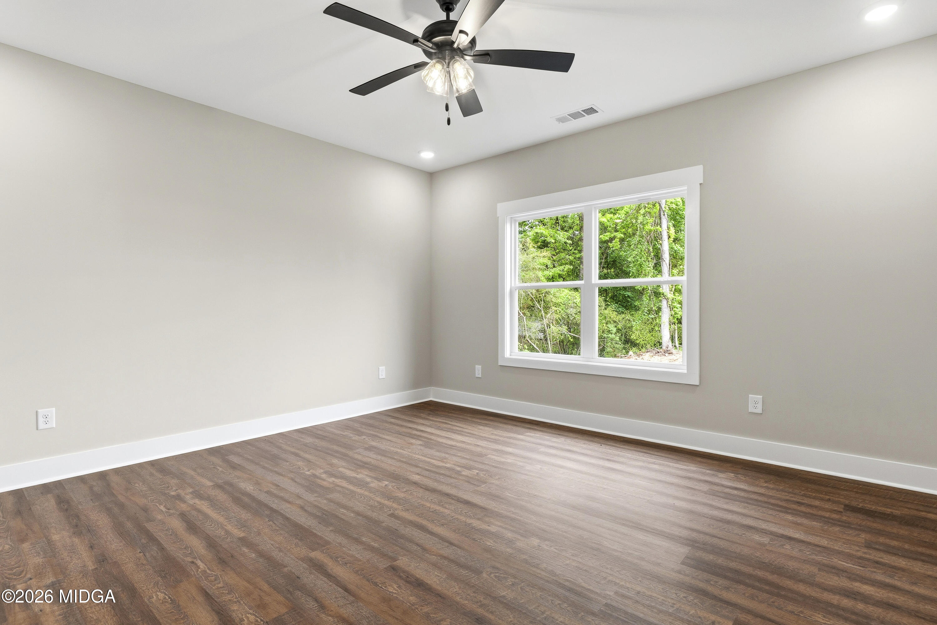146 Overland Way Gray, GA 31032 - Photo 22 of 38 an empty room with wooden floor fan and windows