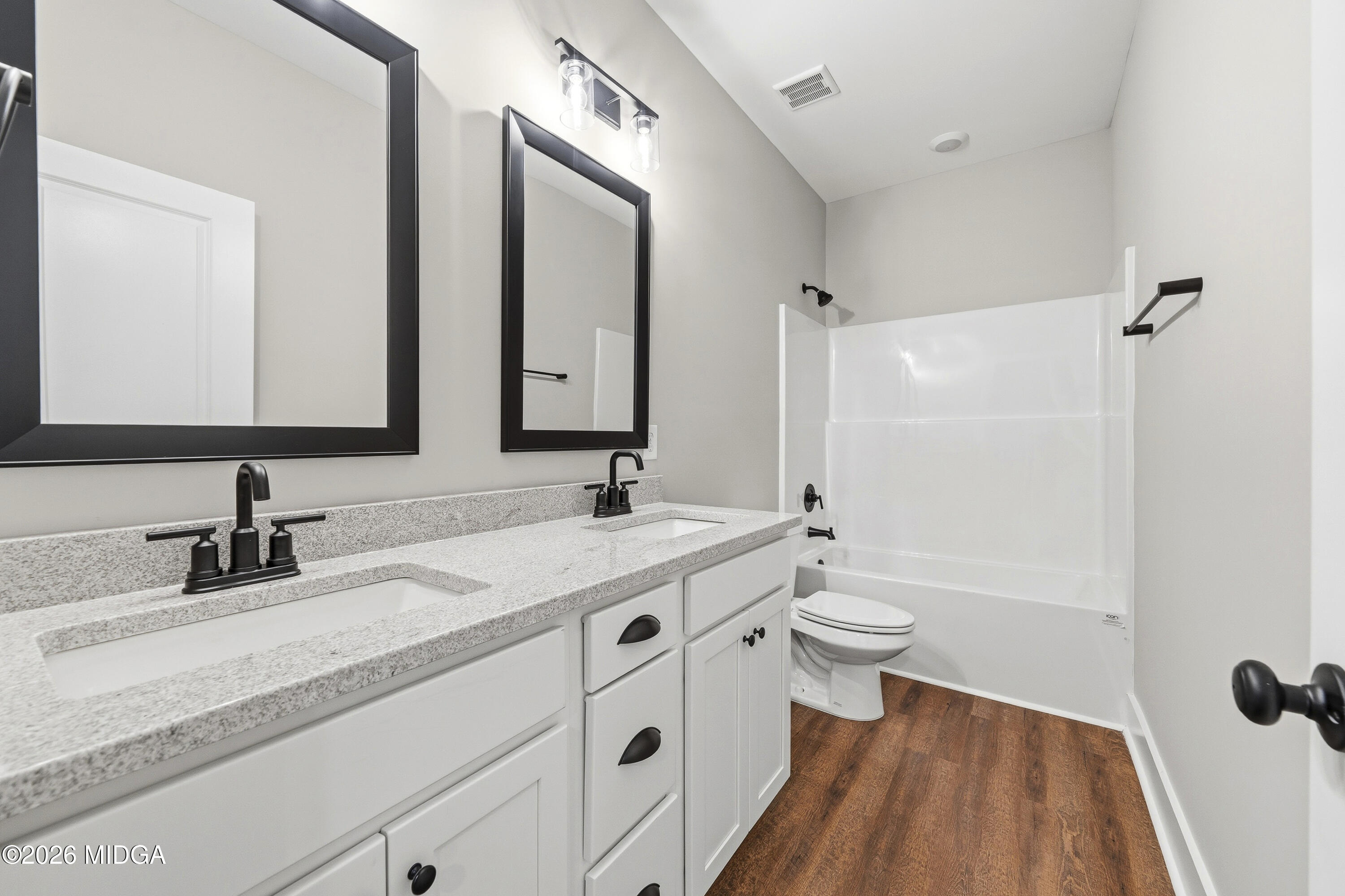 146 Overland Way Gray, GA 31032 - Photo 29 of 38 a bathroom with a double vanity sink toilet mirror and shower