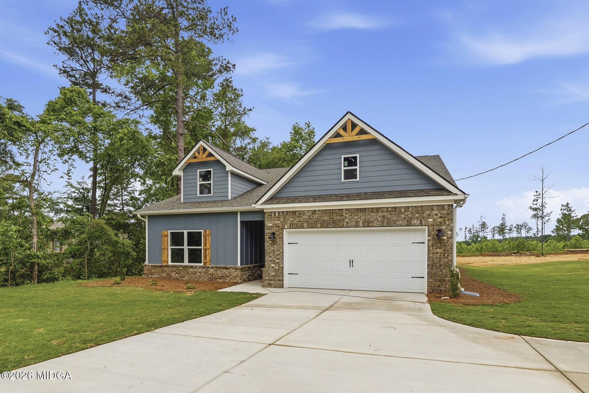 146 Overland Way Gray, GA 31032 - Photo 3 of 38 a front view of a house with a yard and garage