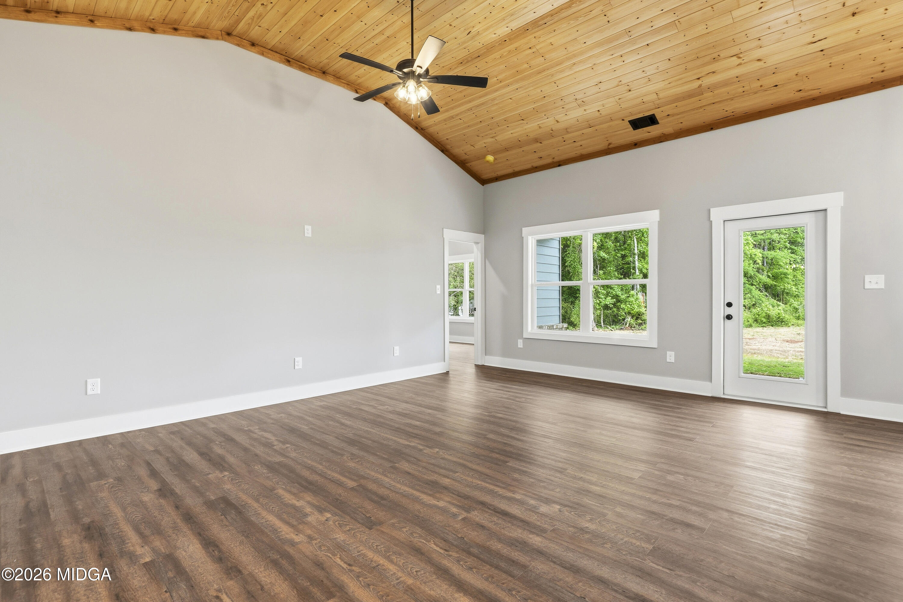 146 Overland Way Gray, GA 31032 - Photo 8 of 38 a view of an empty room with wooden floor and a window