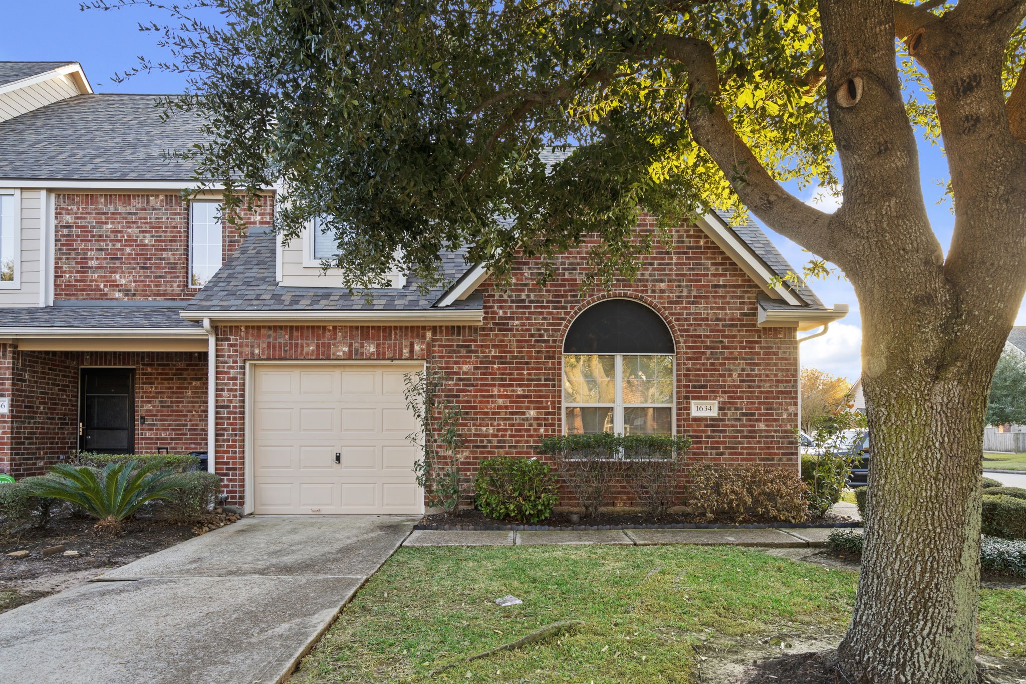 a front view of a house with a garden and yard