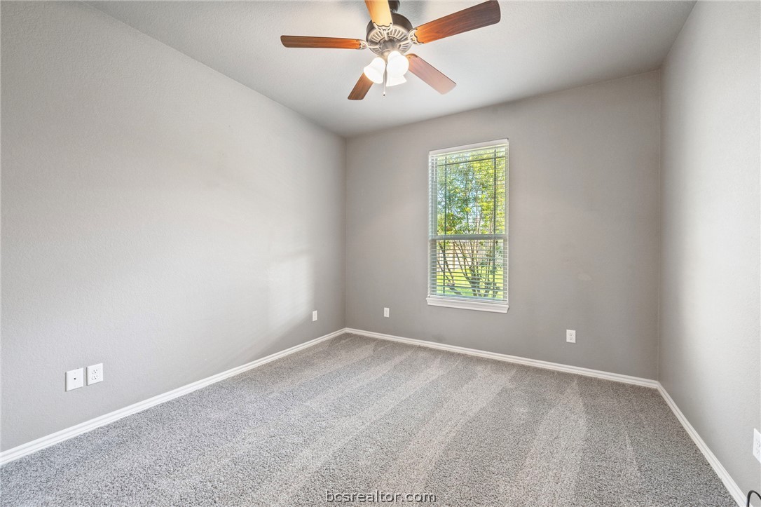 3028 Embers Loop Bryan, TX 77808 - Photo 16 of 26 Carpeted spare room featuring baseboards and a ceiling fan