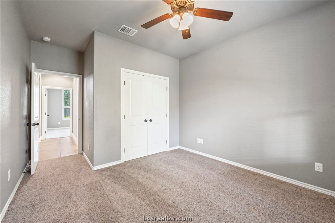 3028 Embers Loop Bryan, TX 77808 - Photo 17 of 26 Unfurnished bedroom featuring carpet floors, a closet, and ceiling fan