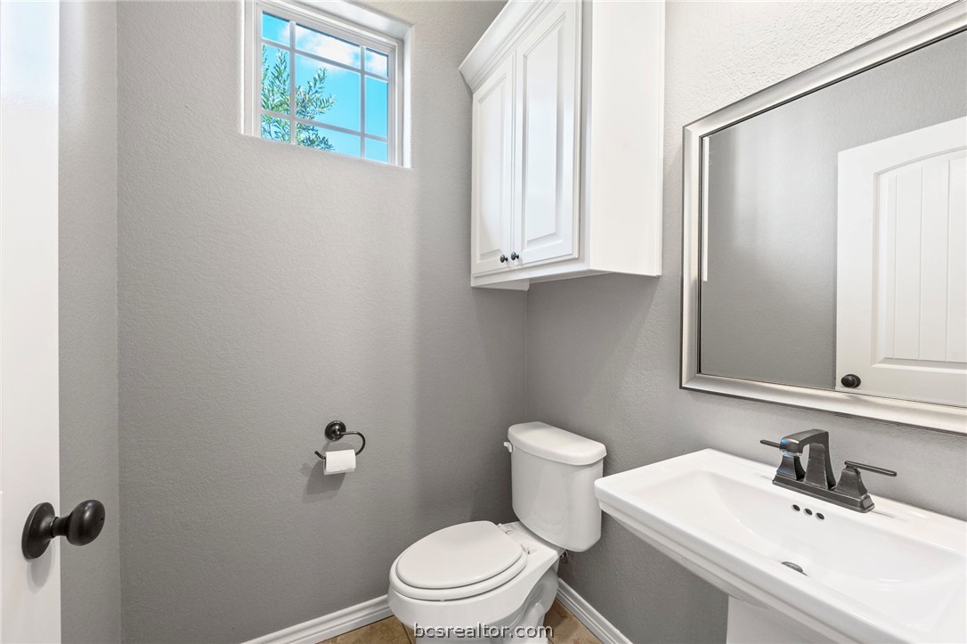 3028 Embers Loop Bryan, TX 77808 - Photo 19 of 26 Half bath featuring a textured wall and light tile patterned floors