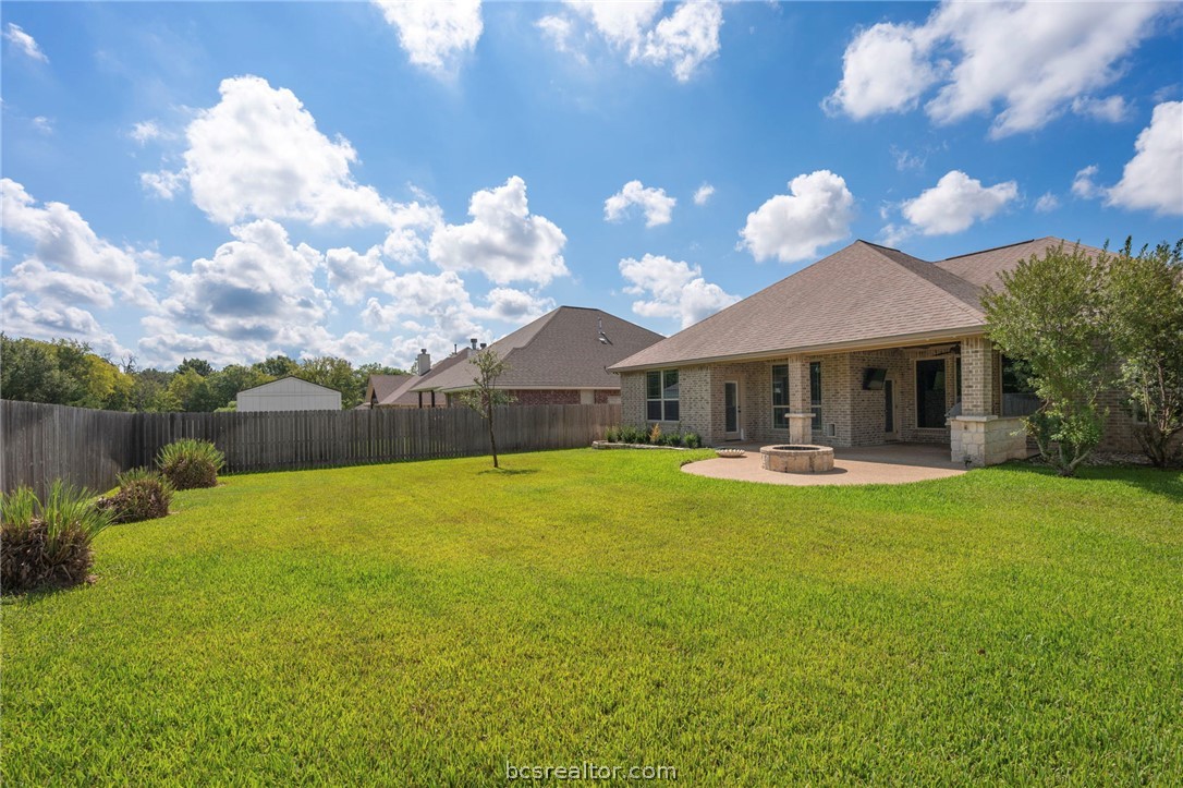 3028 Embers Loop Bryan, TX 77808 - Photo 24 of 26 Back of house with brick siding, a fenced backyard, and a patio area