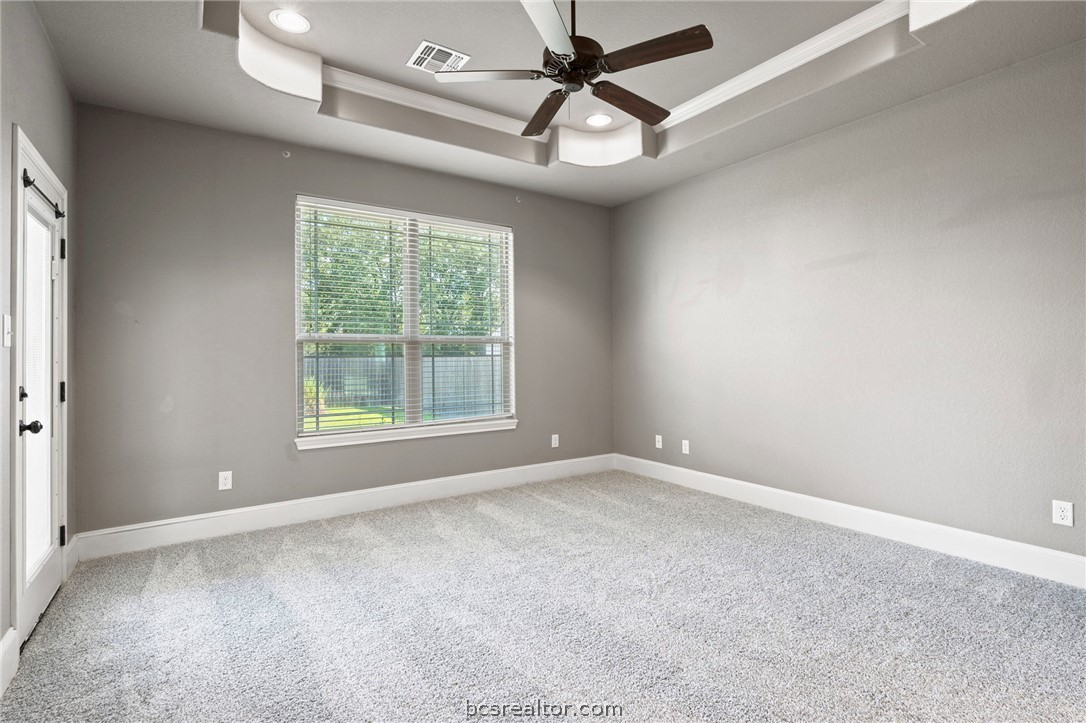 3028 Embers Loop Bryan, TX 77808 - Photo 9 of 26 Spare room with a tray ceiling, light colored carpet, a ceiling fan, recessed lighting, and crown molding