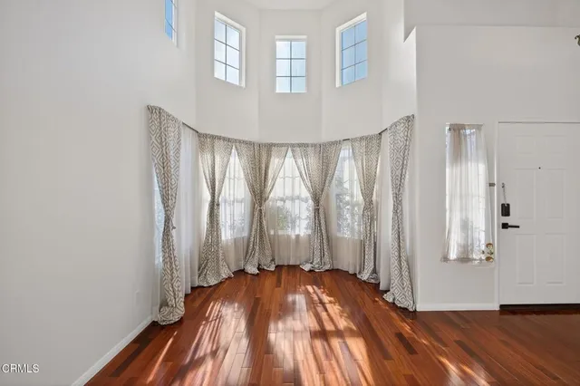 a view of a room with wooden floor and staircase