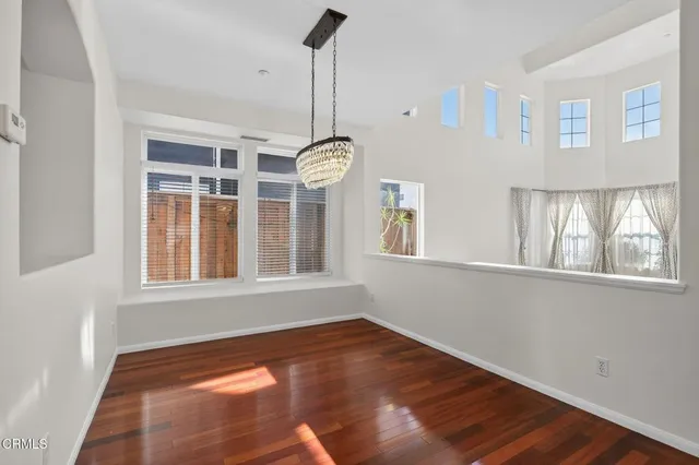 a view of a living room and hallway with wooden floor
