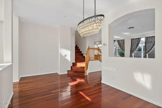 a view of a livingroom with wooden floor and a fireplace