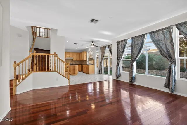 a view of entryway and hall with wooden floor