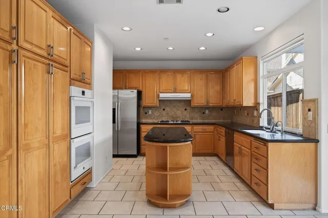 a kitchen with a sink stove and cabinets