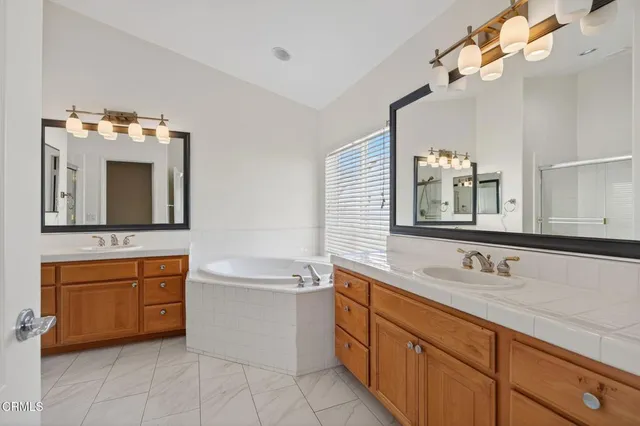 a bathroom with a double vanity sink a mirror and a