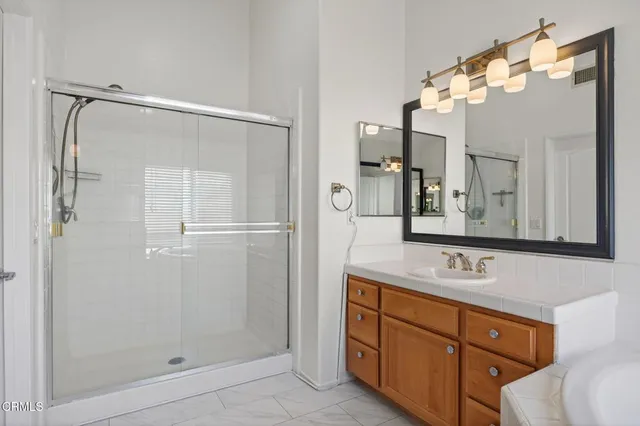 a bathroom with a tub sink and mirror