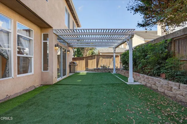 a view of a backyard with plants and a patio