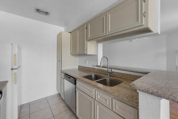 a kitchen with stainless steel appliances granite countertop a sink and dishwasher