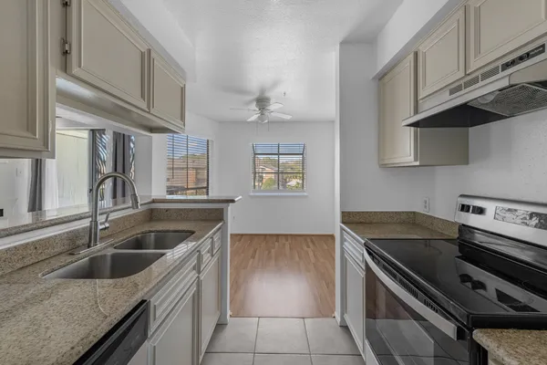 a kitchen that has a sink and a stove