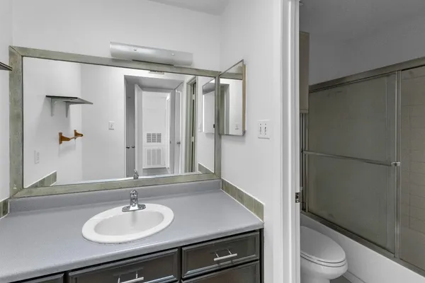 a bathroom with a sink toilet and shower