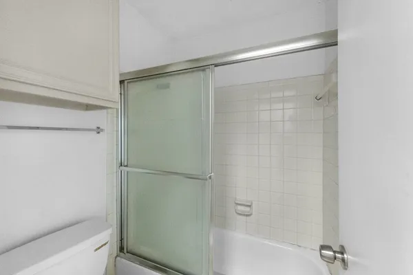 a bathroom with a glass shower door