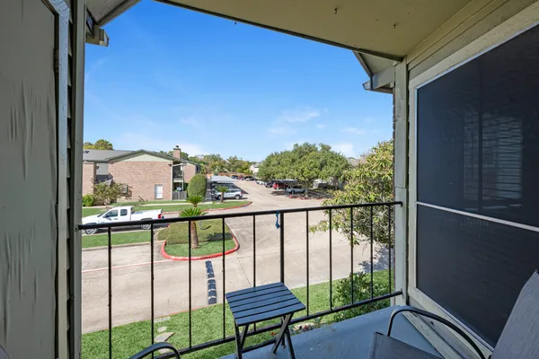 a view of a balcony with furniture