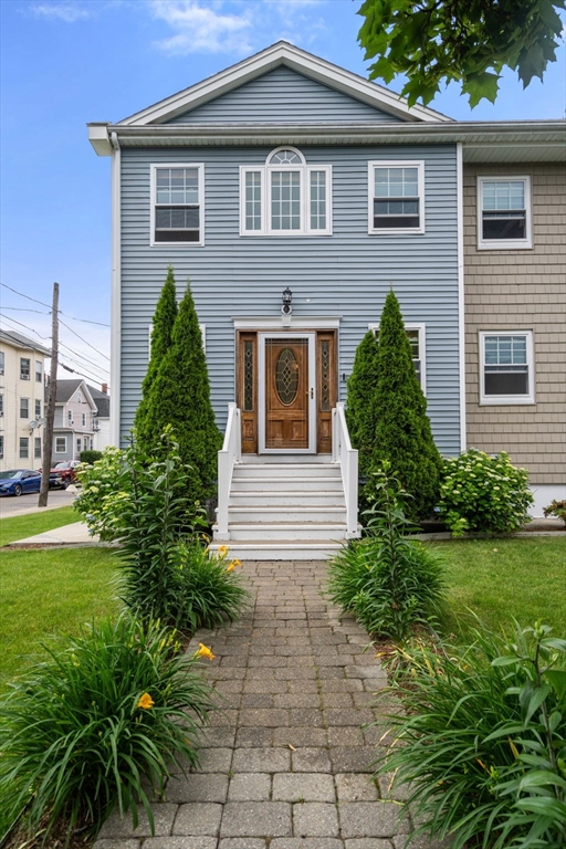 104 Crescent Street, Unit 1 Waltham, MA 02453 - Photo 2 of 30 a front view of a house with garden