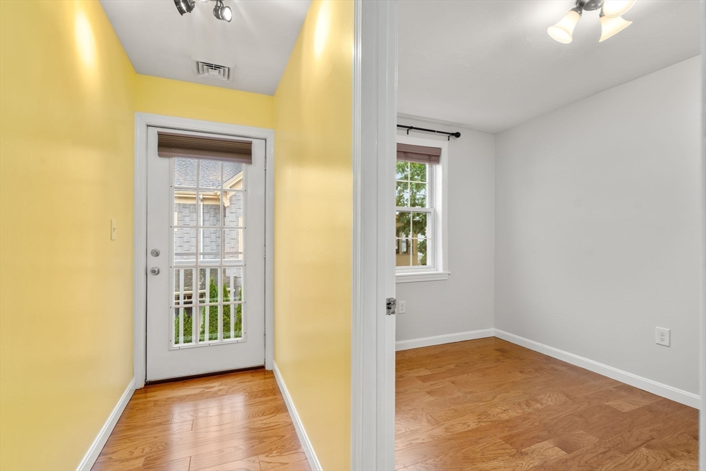 104 Crescent Street, Unit 1 Waltham, MA 02453 - Photo 21 of 30 a view of an empty room with a window