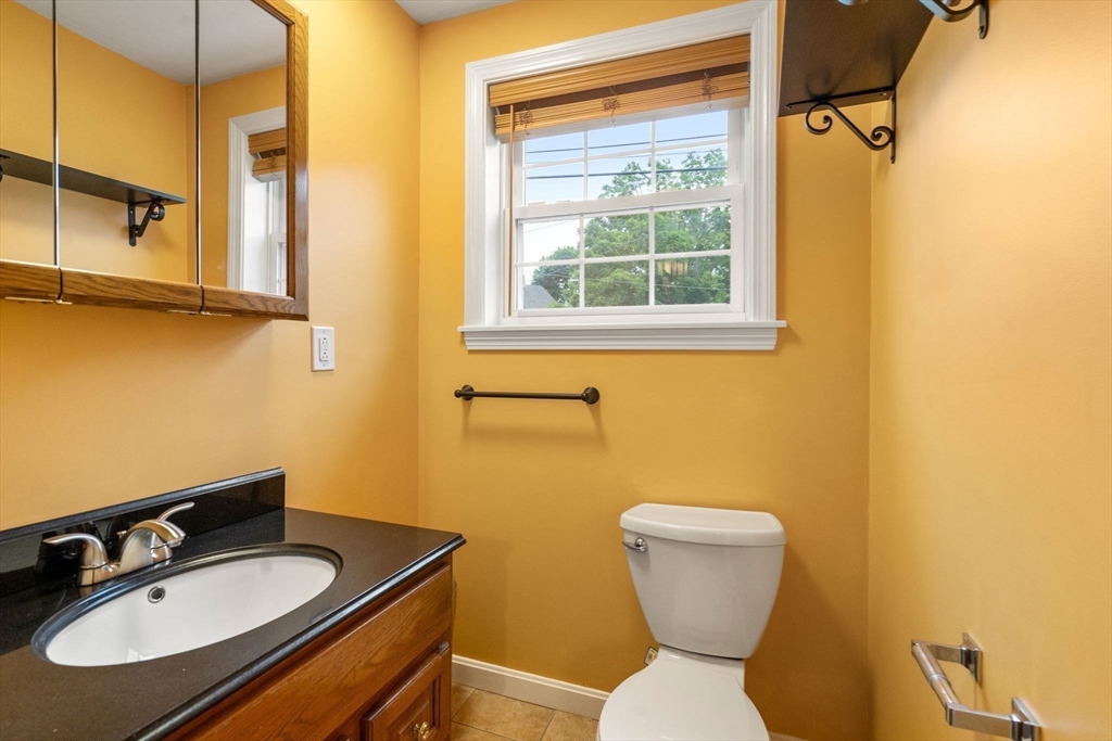 104 Crescent Street, Unit 1 Waltham, MA 02453 - Photo 23 of 30 a bathroom with a sink a toilet and a mirror