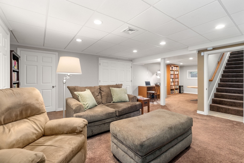 104 Crescent Street, Unit 1 Waltham, MA 02453 - Photo 24 of 30 a living room with furniture and a wooden floor