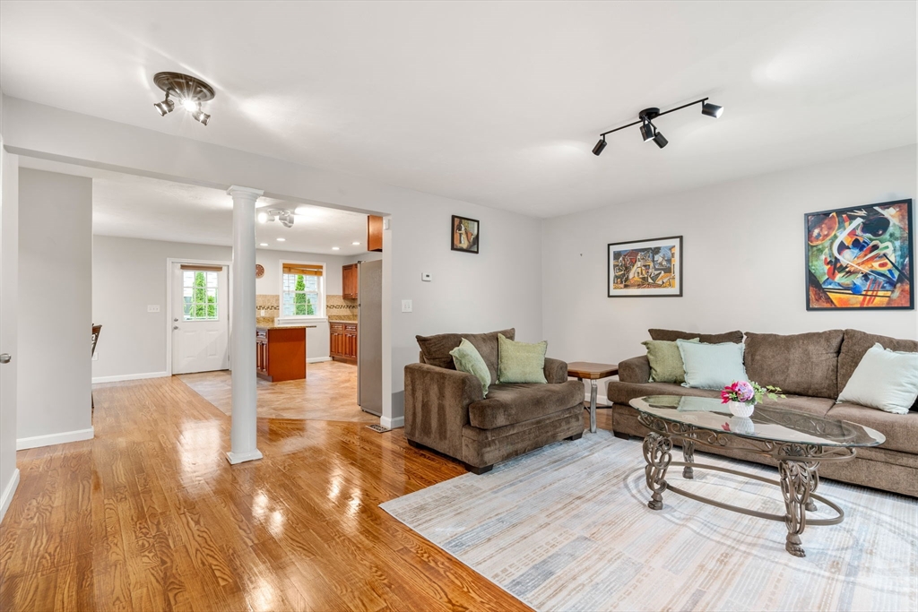 104 Crescent Street, Unit 1 Waltham, MA 02453 - Photo 5 of 30 a living room with furniture and wooden floor