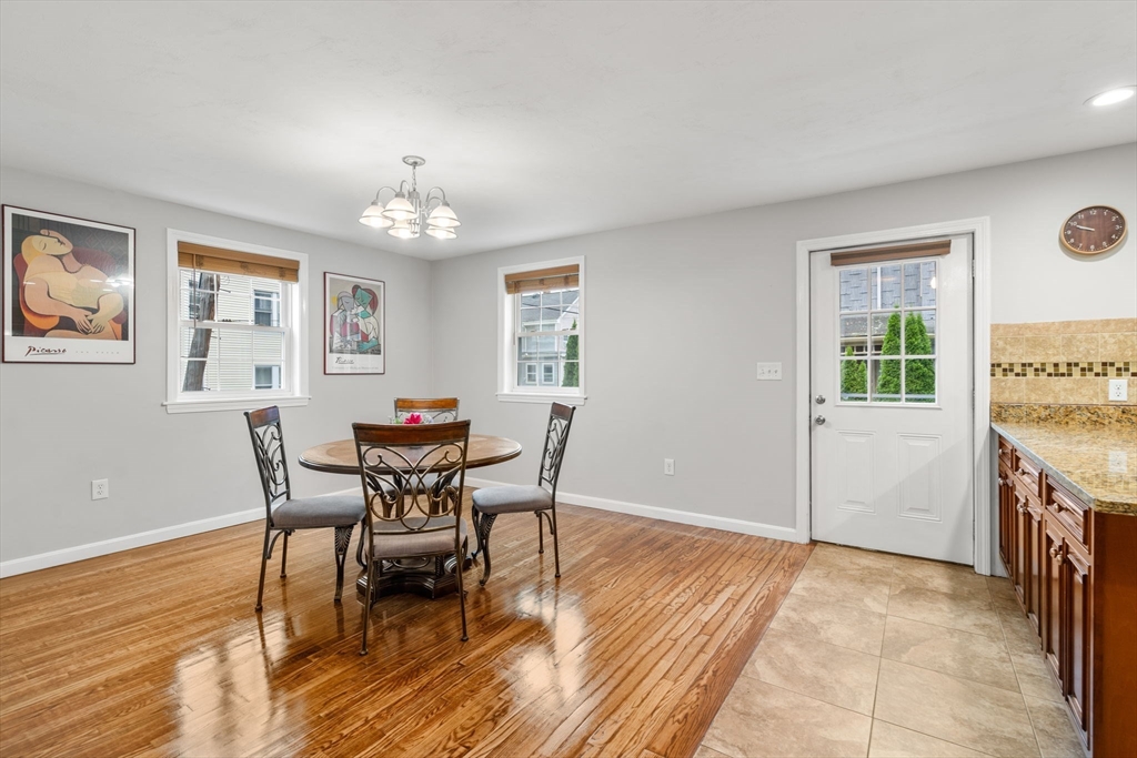 104 Crescent Street, Unit 1 Waltham, MA 02453 - Photo 6 of 30 a view of a dining room with furniture and wooden floor