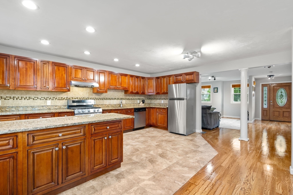 104 Crescent Street, Unit 1 Waltham, MA 02453 - Photo 9 of 30 a kitchen with stainless steel appliances granite countertop a refrigerator and sink