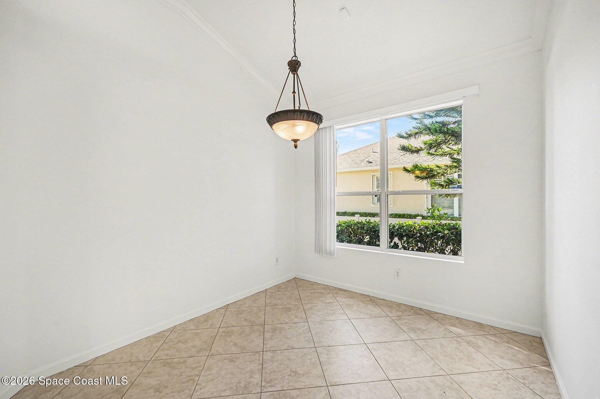 3271 Arden Circle Melbourne, FL 32934 - Photo 11 of 29 a view of a room with a window and a chandelier