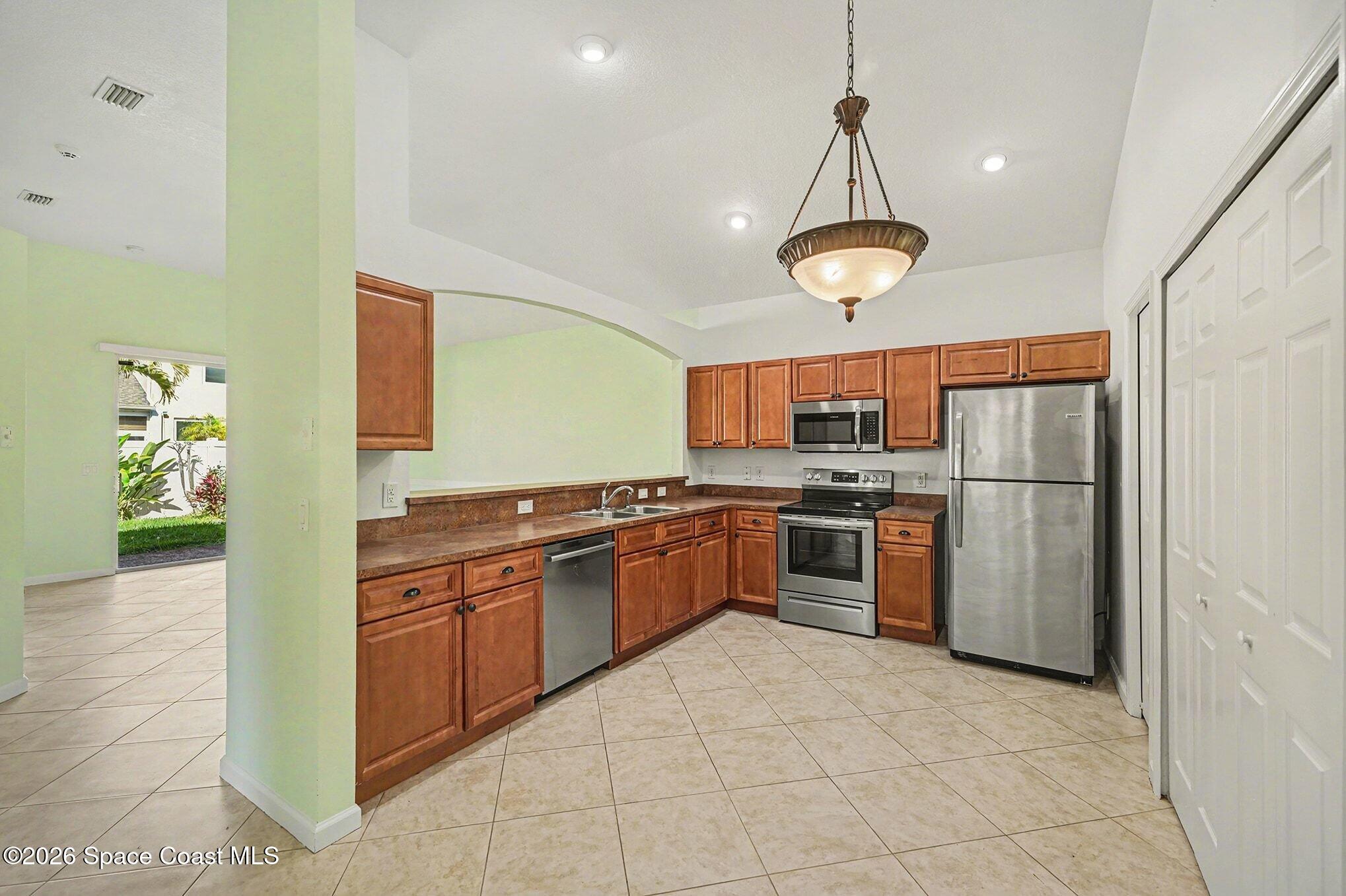 3271 Arden Circle Melbourne, FL 32934 - Photo 17 of 29 a kitchen with stainless steel appliances granite countertop a stove and a refrigerator