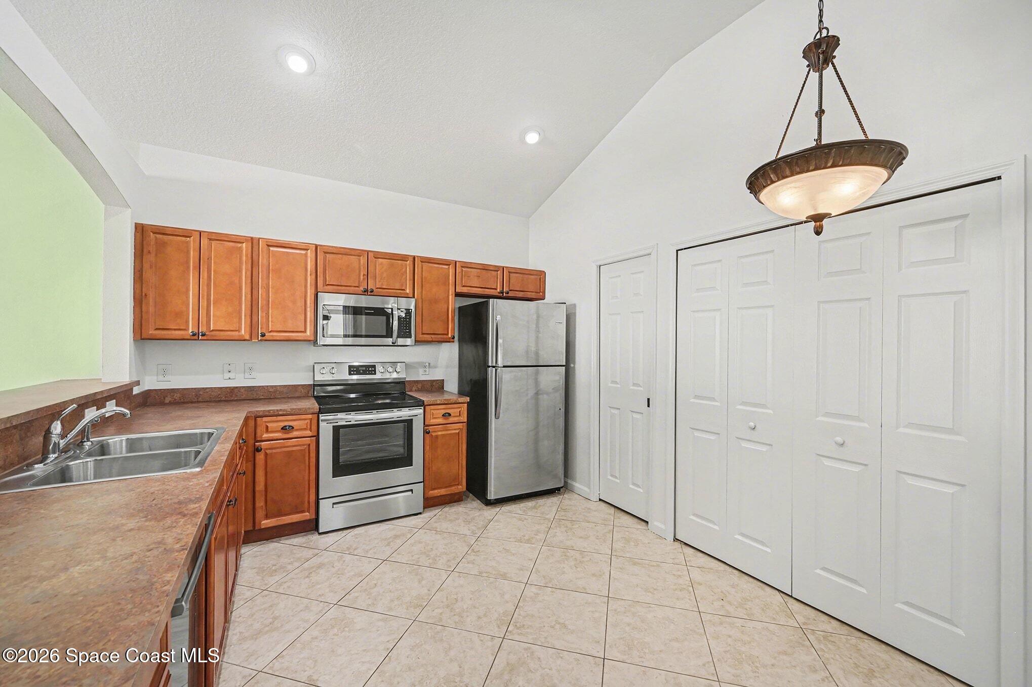 3271 Arden Circle Melbourne, FL 32934 - Photo 20 of 29 a kitchen with stainless steel appliances granite countertop a refrigerator and a sink