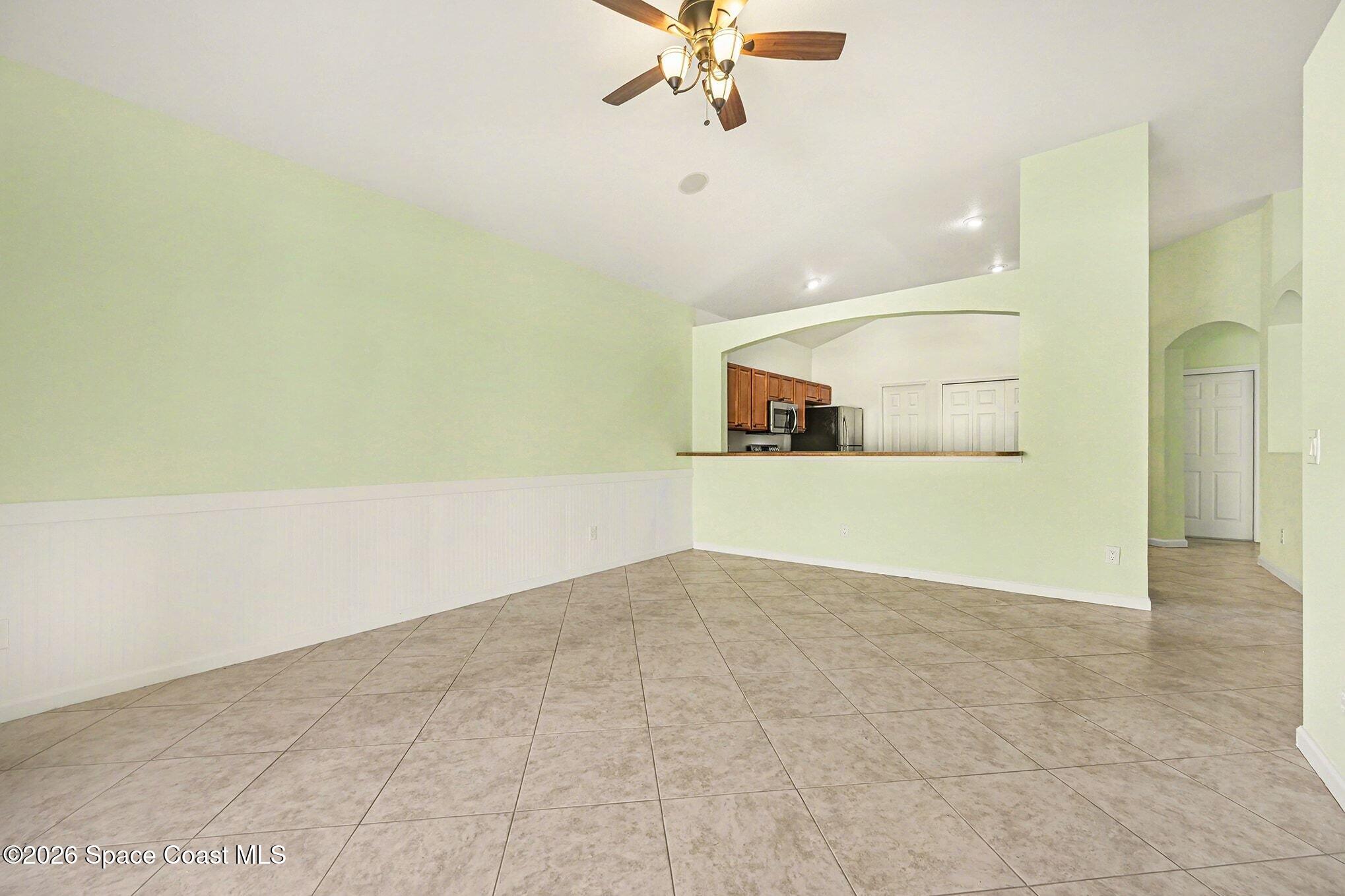 3271 Arden Circle Melbourne, FL 32934 - Photo 5 of 29 an empty room with a ceiling fan and a window
