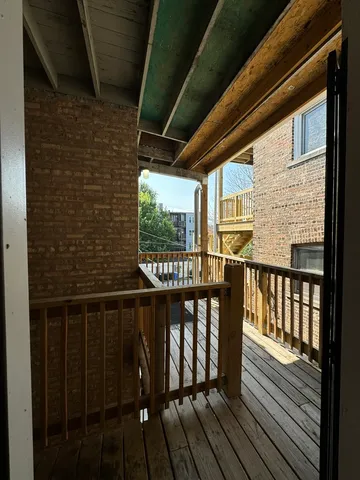 a view of a balcony with wooden floor