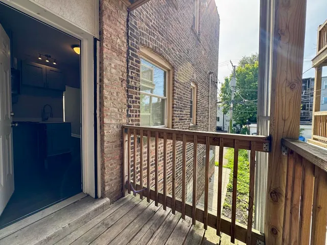 a view of balcony with wooden floor
